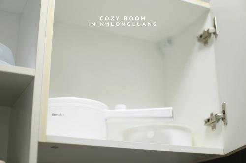 a bathroom with a sink and two faucets at Cozy room in Khlongluang - Self Check-in in Khlong Luang