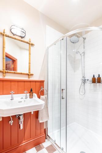 a bathroom with a sink and a shower at The Willows Boutique Stays Central Whitby in Whitby