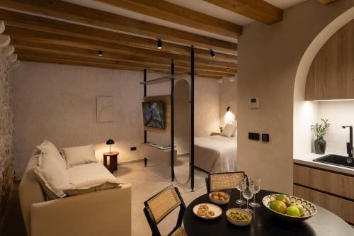 a living room with a couch and a table and a bed at Old Town Olive Studio Apartment in Dubrovnik
