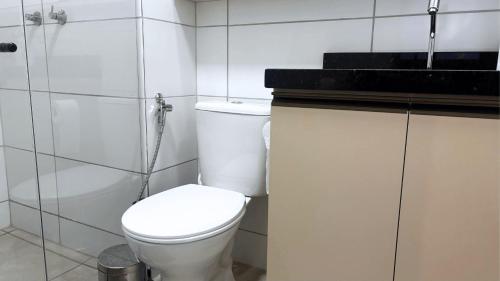 a white bathroom with a toilet and a shower at Max Derby - Studios no Centro do Recife por Yolo in Recife