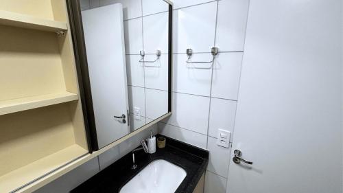 a bathroom with a sink and a mirror at Max Derby - Studios no Centro do Recife por Yolo in Recife