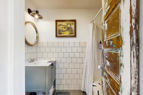 a bathroom with a sink and a mirror at Calm Waters in Rockaway Beach