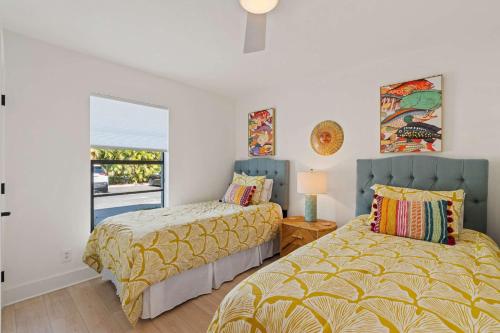 a bedroom with two beds and a window at Exquisite Luxury First Floor Condo - Easy Walk to Amenities in Naples