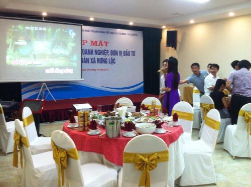 a group of people standing around a table with food on it at Vinh Plaza Hotel in Vinh