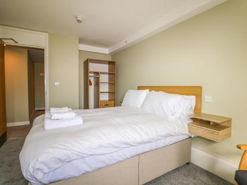 a bedroom with a large bed with white sheets and pillows at Flat 32 - Marine Court in Littlehampton