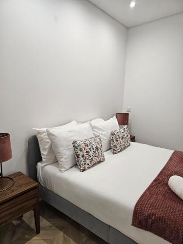 a bedroom with a bed with two pillows on it at City Center Terrace in Faro