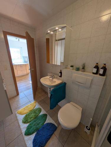 a bathroom with a toilet and a sink at Apartment im Grünen in Ettlingen