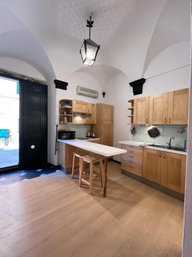 a kitchen with wooden cabinets and a table in it at Casa Camalì in Levanto