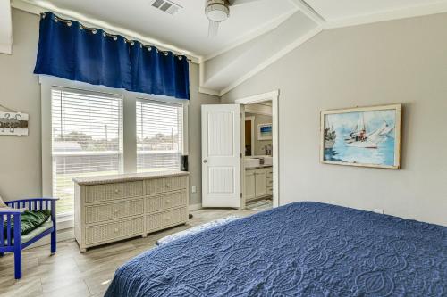 a bedroom with a blue bed and a window at 2 Blocks From Aransas Bay Family Home with Patio! in Fulton