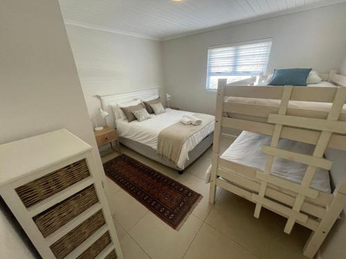 a bedroom with two bunk beds and a ladder at Views galore in Kleinmond in Kleinmond