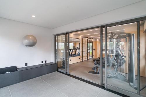 a fitness room with glass doors and a gym at Go Balkon - Studios por temporada in Sao Paulo