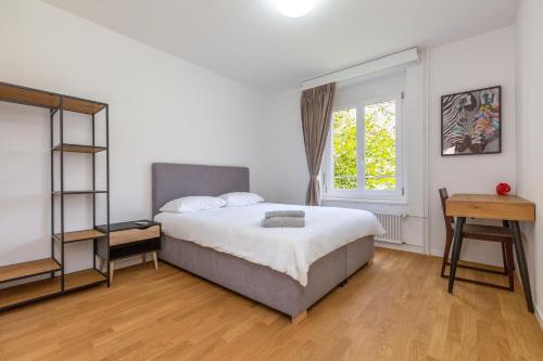 a bedroom with a large bed and a window at KAYA Zurich Apartment 3A - Downtown 2BR Apt with Balcony in Zürich