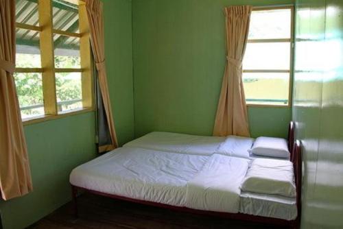 Säng eller sängar i ett rum på Kinabalu Poring Vacation Lodge