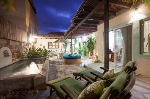 a patio with a pool and chairs and a house at Casa Abuelita: An exquisite, historic La Paz home in La Paz