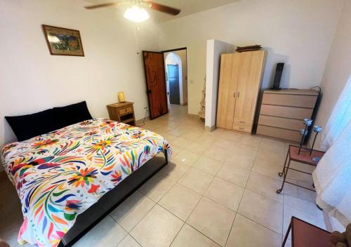 a bedroom with a bed with a colorful comforter at Desert Oasis in El Dorado Ranch - San Felipe Resort Rental Home in Playa El Paraíso