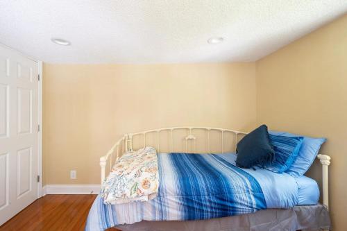 a bedroom with a bed with blue pillows on it at Modern 3-bedroom, big fence yard, Pets stay free in Durham