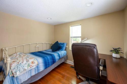 a bedroom with a bed and a desk and a chair at Modern 3-bedroom, big fence yard, Pets stay free in Durham