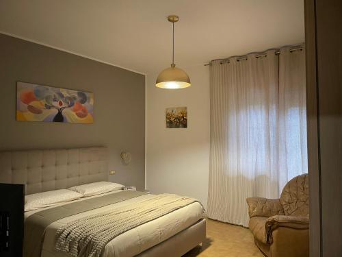 a bedroom with a bed and a chair at Le Pianelle in Pianella