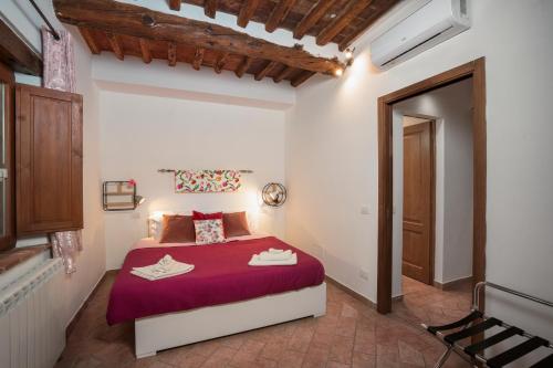 a bedroom with a bed with a red bedspread at Casa Matilde Chianti - Jeky Stay in Castelnuovo Berardenga