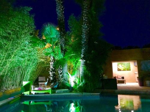 a house with a swimming pool at night at Luxury house in Agde