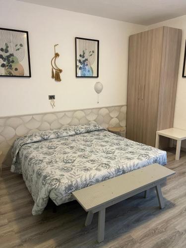 a bedroom with a bed and a table in it at Affittacamere Cà della Roggia in Rovereto