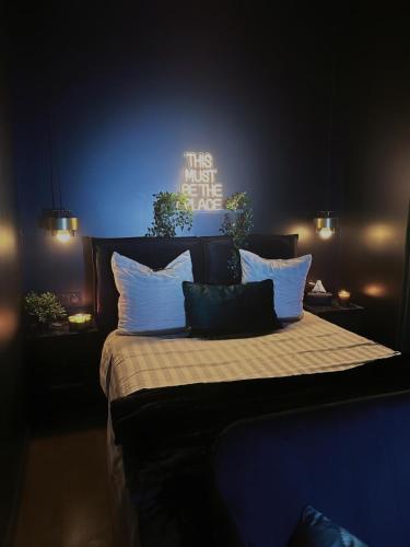 バニョレにあるLove & Spaのベッドルーム1室(壁に看板付)