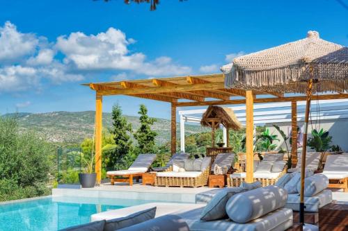 a villa with a swimming pool and a pavilion at Myzith Luxury Suites in Keri