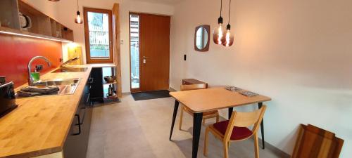 a kitchen with a wooden table and a dining room at Erholen am See in Lychen