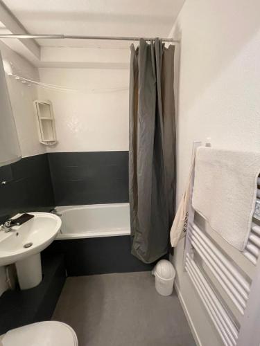 a bathroom with a sink and a toilet and a shower at Appartement Port d'Arcachon in Arcachon