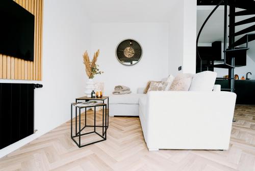 a living room with a white couch and a table at Lake House 10 - 4 Person Lake view Apartment! in Offingawier