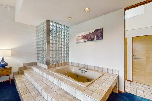 a bath tub in a bathroom with a window at Green Vale Getaway - 2 Bed 2 Bath Vacation home in Sea Ranch in Sea Ranch