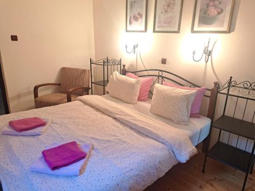 a bedroom with a bed with two towels on it at Salaš Đorđević in Subotica
