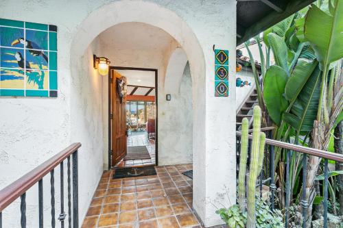 a hallway of a house with a door and some plants at 130MT 130 Middle Terrace in Avalon