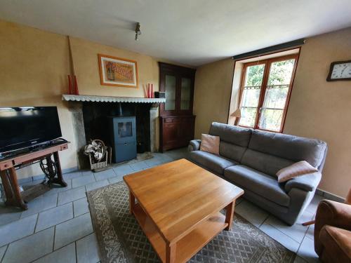 a living room with a couch and a coffee table at Chez nina in Saint-Éloi