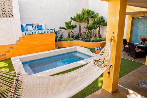 a hammock in a backyard with a pool at Casa Oasis in La Paz
