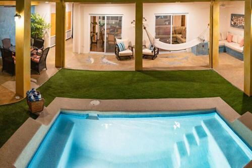 a large swimming pool with a hammock in a house at Casa Oasis in La Paz