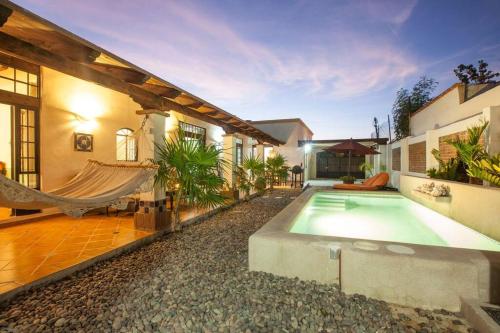 a house with a swimming pool and a hammock at Casa de los Santos in La Paz