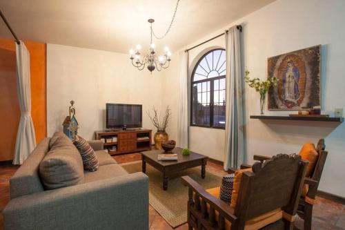 a living room with a couch and a tv at private Pool, walk to malecón, 2 BR estilo hacienda in La Paz
