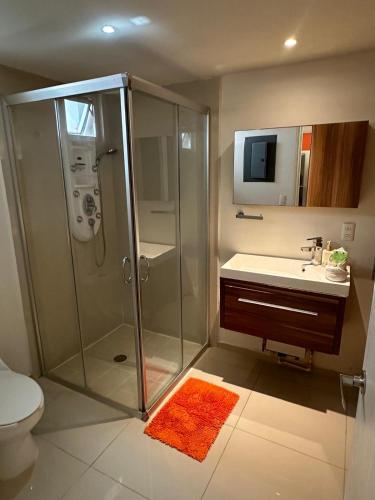 a bathroom with a shower and a sink and a toilet at Increíbles condominios con vista al mar in Tangolunda