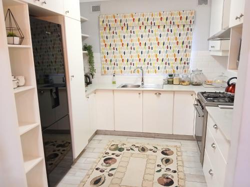 a kitchen with a sink and a kitchen rug on the floor at Hope at Mangaliso in Hilton