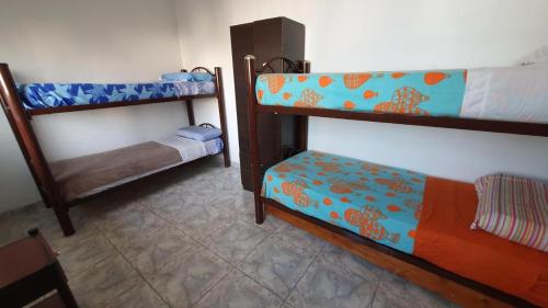 a room with two bunk beds in a room at Hostelmo Hotel in Buenos Aires