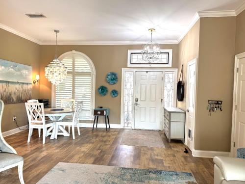 a living room with a table and a dining room at Sarasota Charm in Sarasota