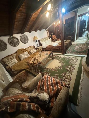 a room with couches and a table and a rug at Archontiko Brides of Meteora in Kalabaka