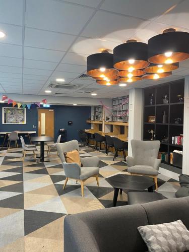 a waiting area with chairs and tables in a library at Market House in Newcastle in Newcastle upon Tyne