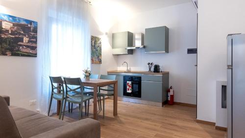 a kitchen and dining room with a table and chairs at Orvieto Residence in Orvieto