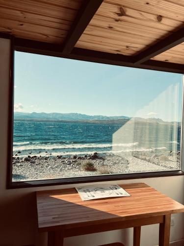 a large window with a view of the ocean at Nogal in San Carlos de Bariloche