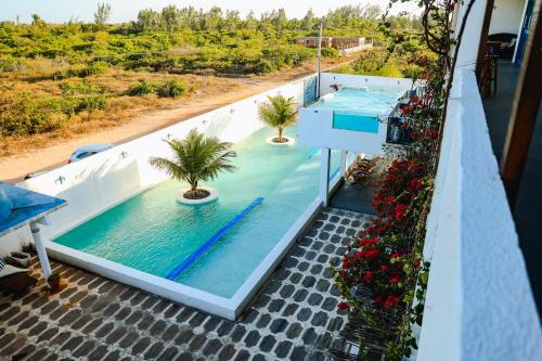 a swimming pool on the balcony of a house at Pousada La Grécia in Camocim