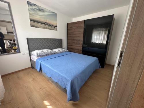 een slaapkamer met een bed met een blauwe deken bij Apartman Little Dream in Split