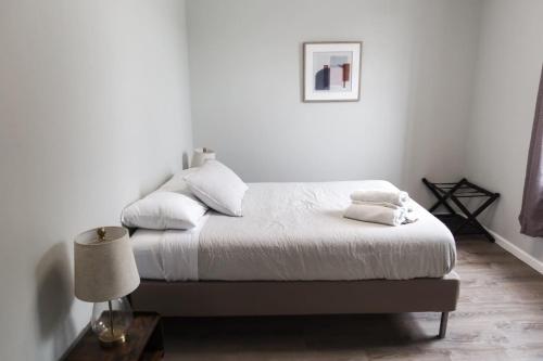 a bedroom with a bed with white sheets and pillows at 3Bed 2Bath Apt Near NYC plus Parking and Laundry in Irvington