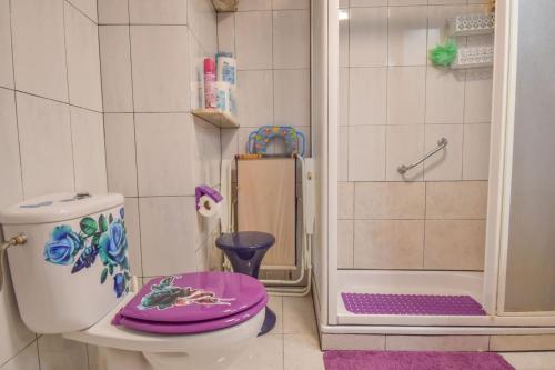 a bathroom with a purple toilet and a shower at Sweetstaybykw Dean Llopez Stay in Santa Pola